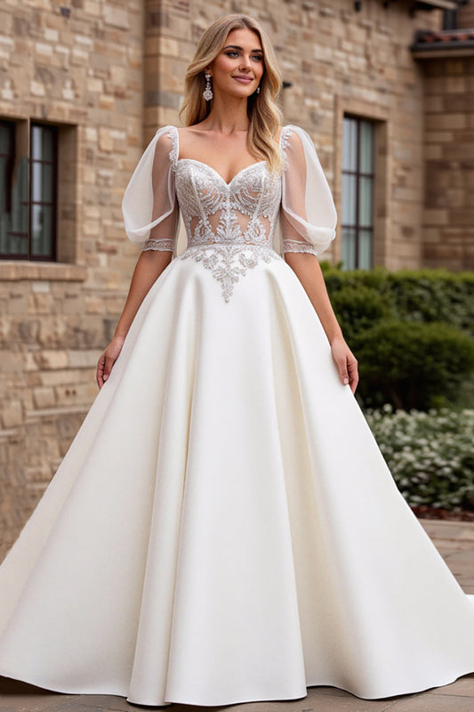 Vestido de novia largo con apliques y mangas francesas color marfil línea A