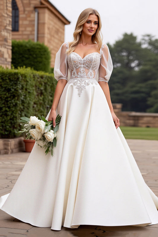 Vestido de novia largo con apliques y mangas francesas color marfil línea A