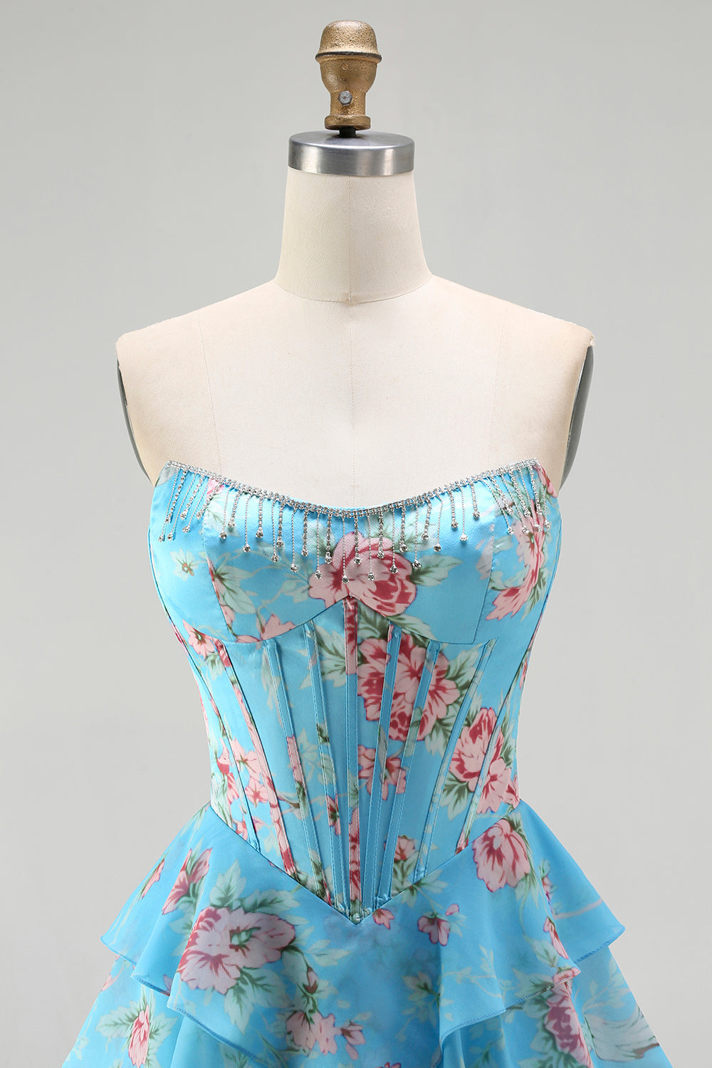 Robe de bal longue bleu foncé sans bretelles coupe trapèze avec bustier corset floral et jupe en mousseline à volants