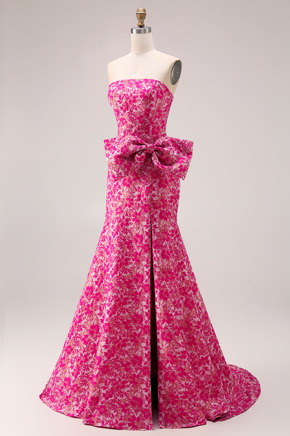 Vestido largo de fiesta tipo sirena con abertura lateral, estampado floral fucsia y lazo, sin tirantes