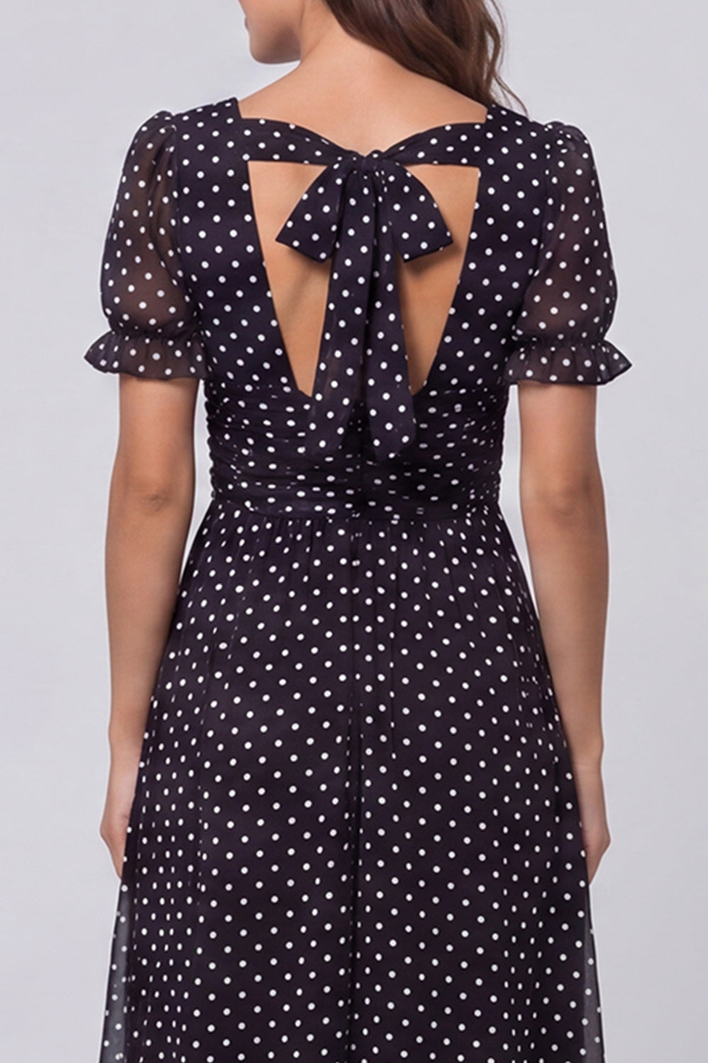 Robe de travail mi-longue à pois noirs et blancs, décolleté carré et manches bouffantes