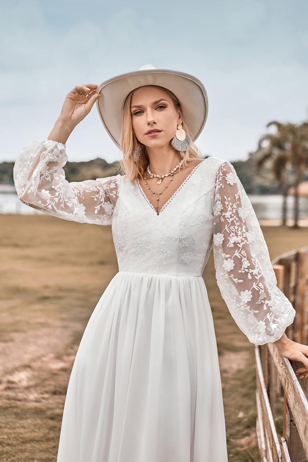 Robe de mariée bohème en mousseline ivoire coupe trapèze avec décolleté en V, traîne balayante et dentelle