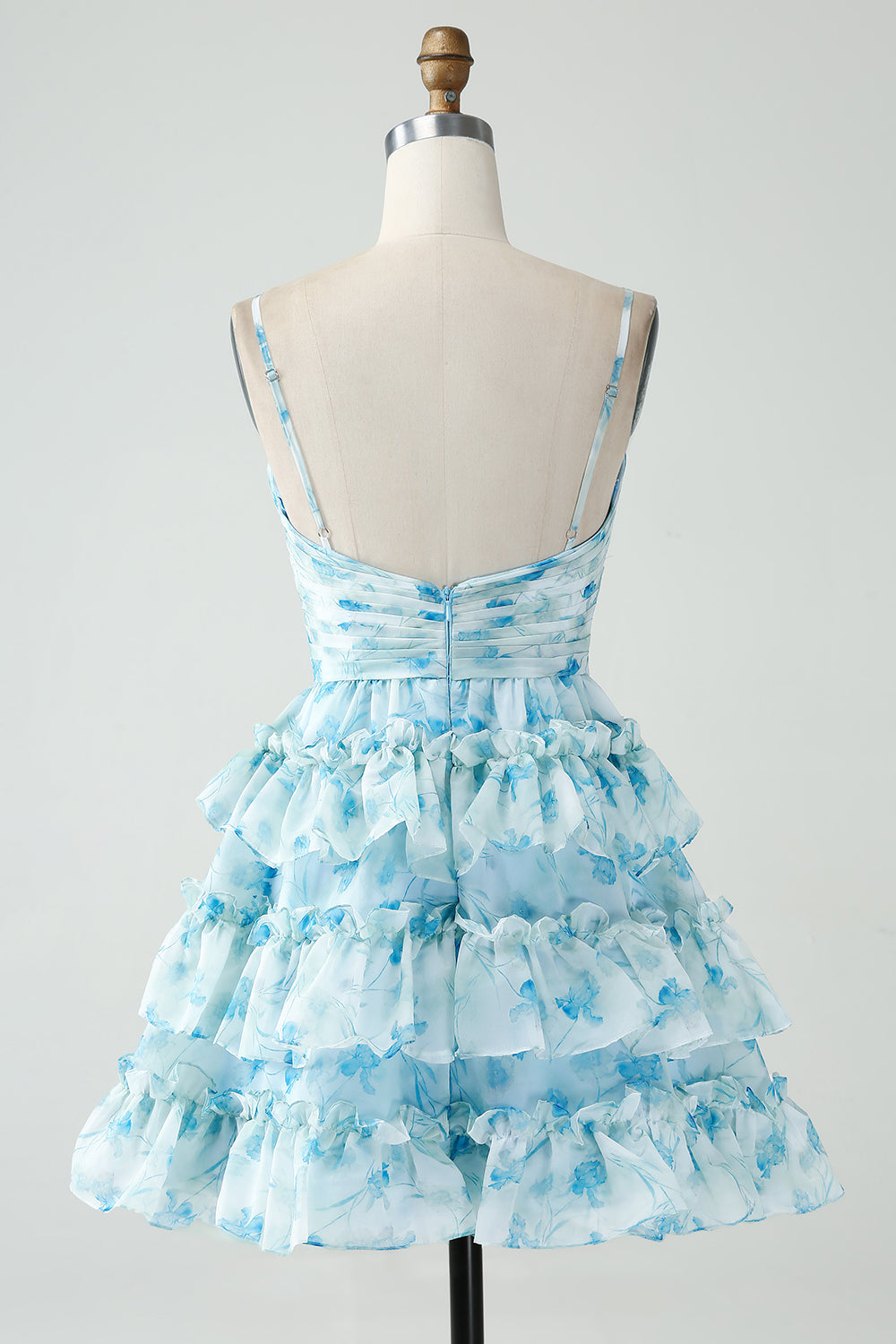 Robe courte de bal de fin d'année florale bleue à bretelles spaghetti et à volants de forme trapèze