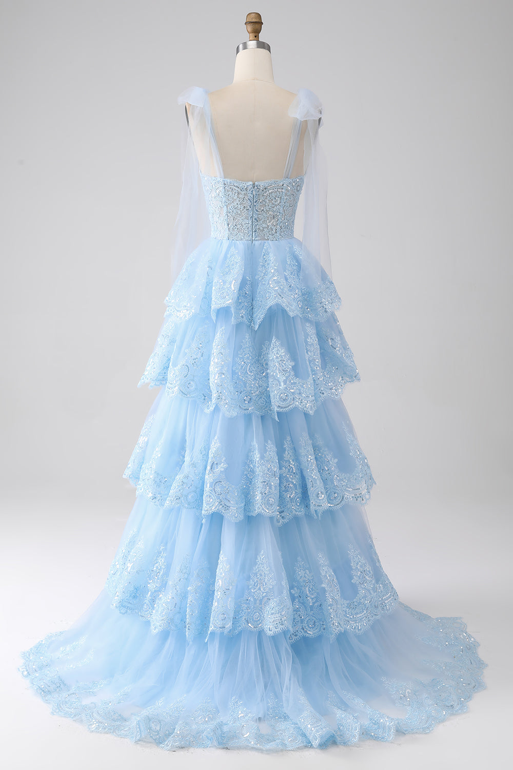 Robe de bal en tulle étagée avec paillettes et appliqués, bretelles nœud papillon, couleur bleu clair